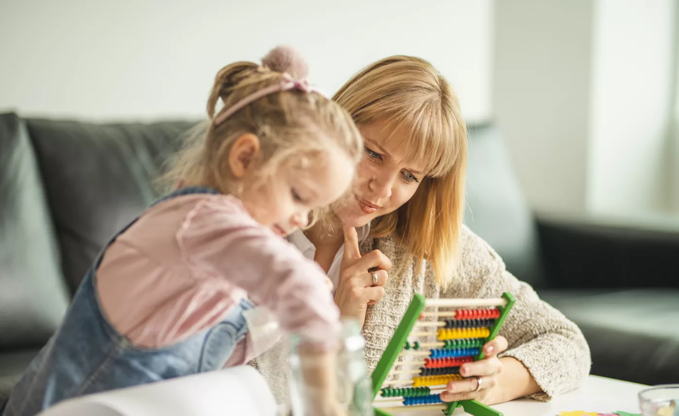  A young mother and her daughter work on a puzzle game together.
